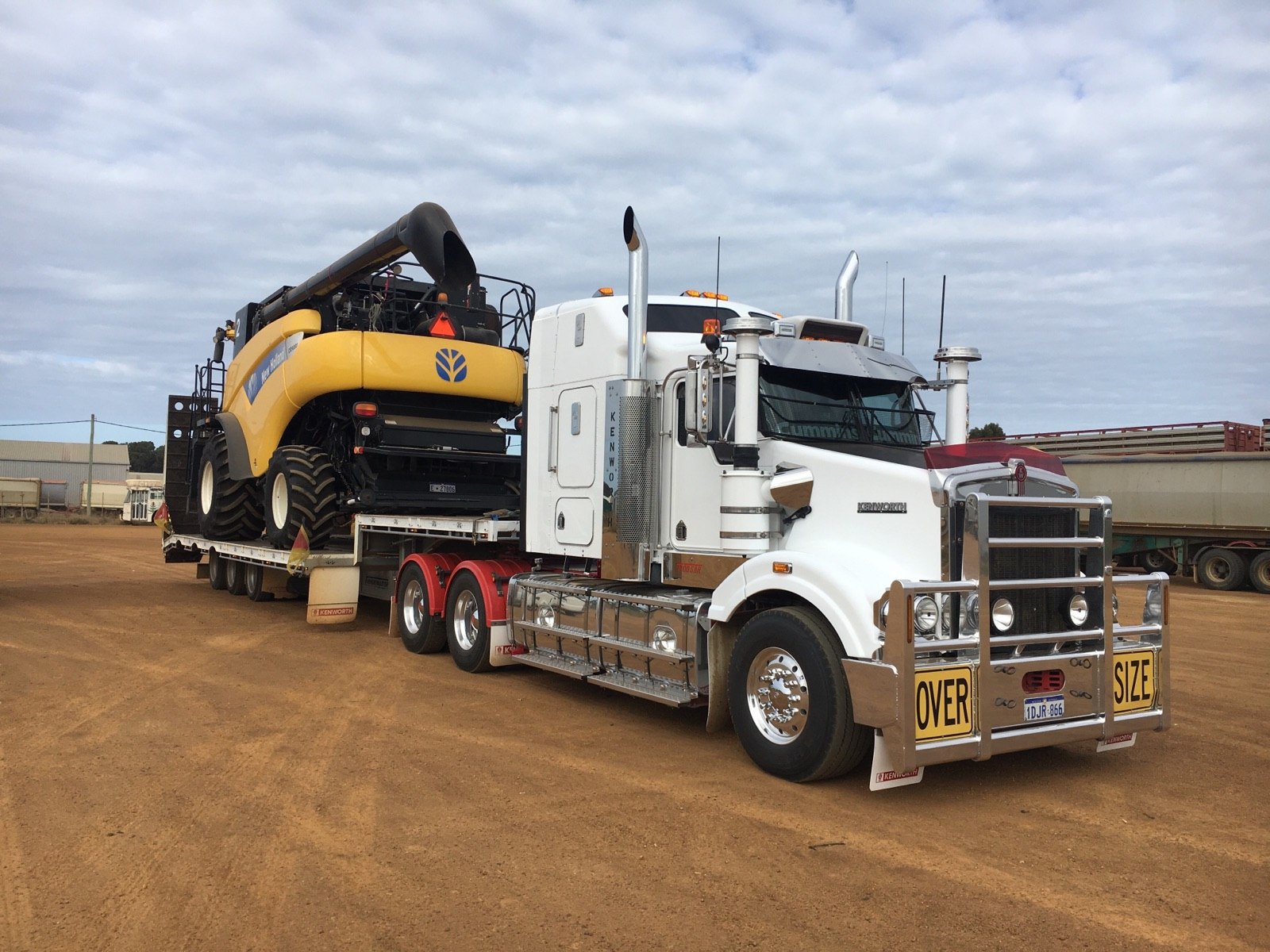 Prime mover transporting a combine harvester through regional WA