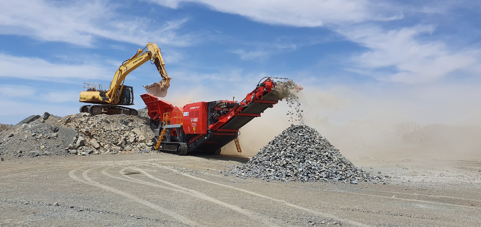 Excavator and rock crusher working at a Western Australian quarry